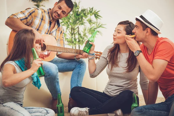 Four Cheerful Friends Hanging Out Guitar Beer Apartment — Stock Photo, Image