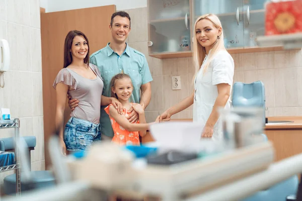 young family in visit at dentist office