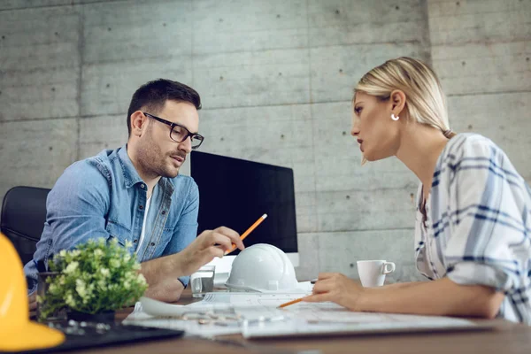 Young Pensive Architect Colleagues Analyzing Blueprints Talking Office — Stock Photo, Image