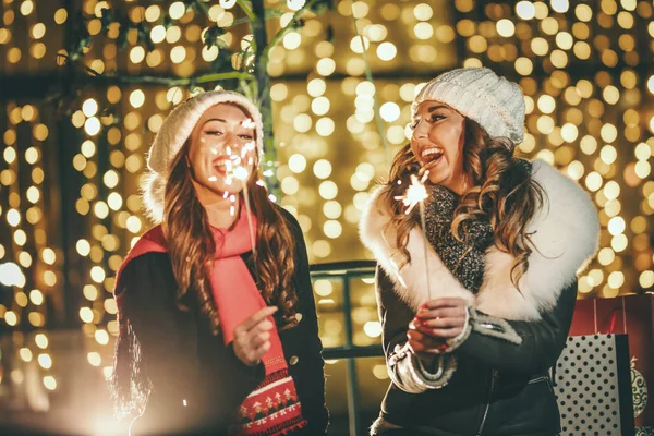 Cheerful Young Female Friends Holding Sparklers Having Fun Holiday Winter — Stock Photo, Image