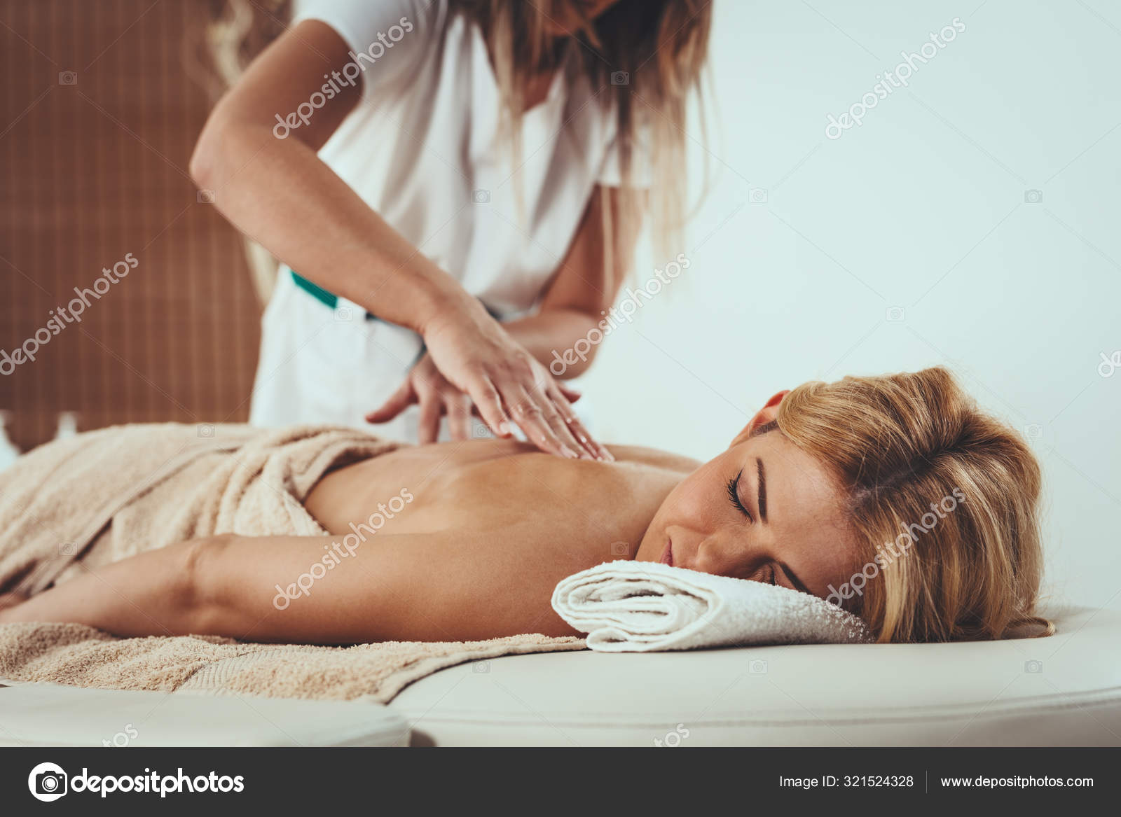 Young woman receiving a back massage in a spa center stock photo
