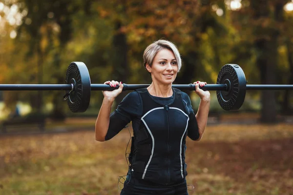 Smiling Mature Woman Doing Exercises Barbell Park Dressed Black Suit — Stock Photo, Image