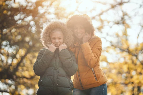 Beautiful Mother Her Happy Teenage Daughter Holding Jacket Hoods Faces — Stock Photo, Image