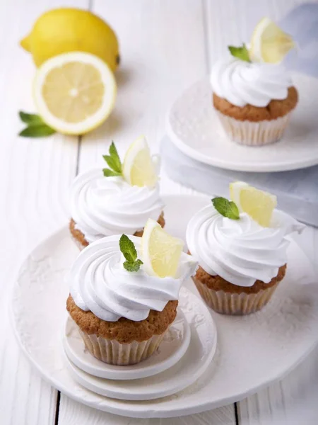 Lemon cupcakes with cream on Swiss meringue