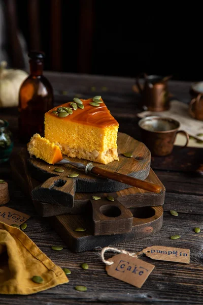 slice of pumpkin cheesecake with caramel sauce and seeds on top