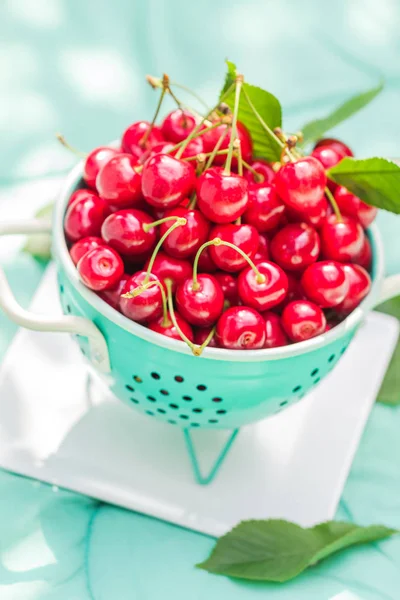 Fresh red cherry fruit green colander — Stock Photo, Image