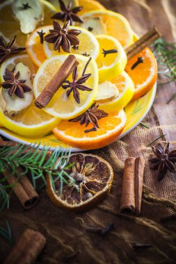 Ingredients for medicinal tea. Citrus and spices. Slices of lemon, orange, ginger, cloves and cinnamon. clipart