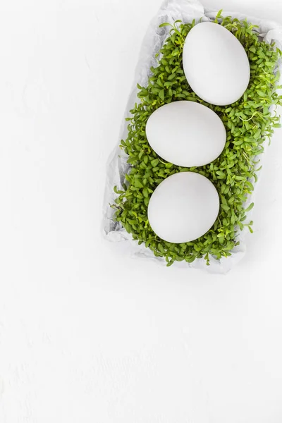 White Easter background eggs green cress — Stock Photo, Image