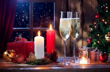 close up view of champagne with candles and gifts on color back clipart