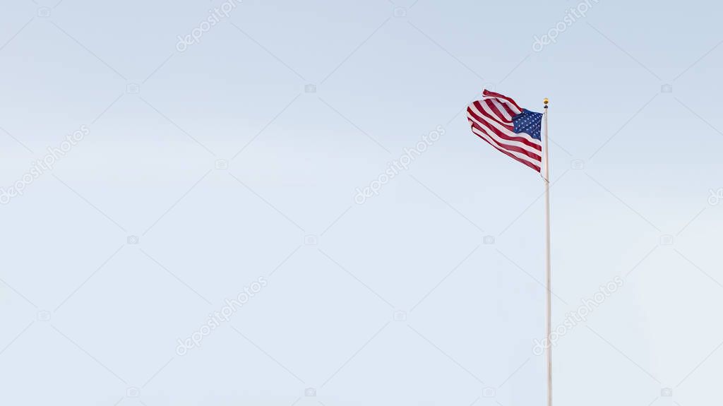 view of American flag on blue sky back. banner. lots of space for your text