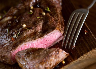 close up view on nice fresh steak on color background clipart