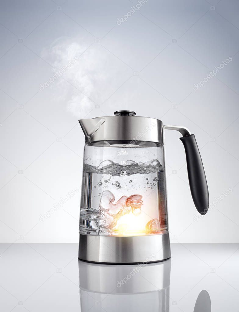 close up view of nice metal tea kettle on grey color background