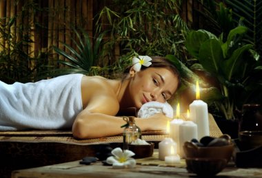 portrait of young beautiful woman in spa environment.  clipart