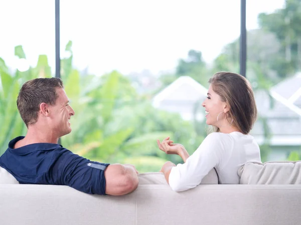 View of nice young couple is sitting on sofa in summer house — Stock Photo, Image