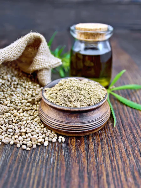 Flour hemp in bowl with oil on board — Stockfoto