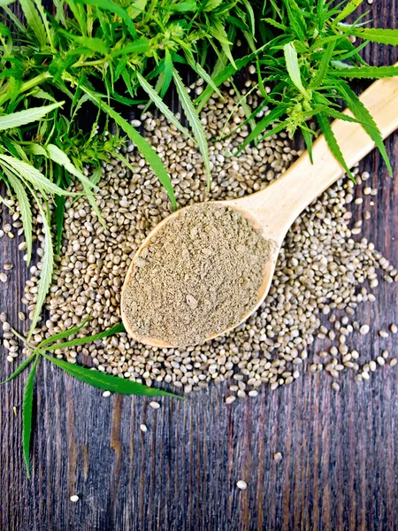 Flour hemp in spoon with leaf on board top — Stock Photo, Image