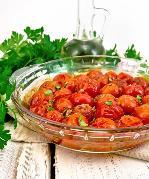 Tomatoes baked in pan on light board — Stock Photo, Image