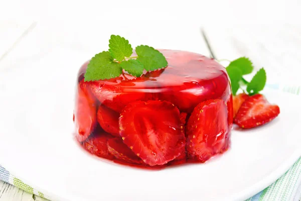 Jelly strawberry with mint in plate on board — Stock Photo, Image