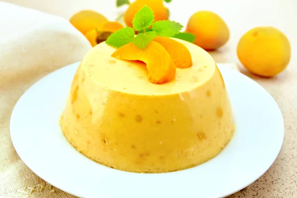 Panna cotta apricot with mint and fruit on table — Stock Photo, Image