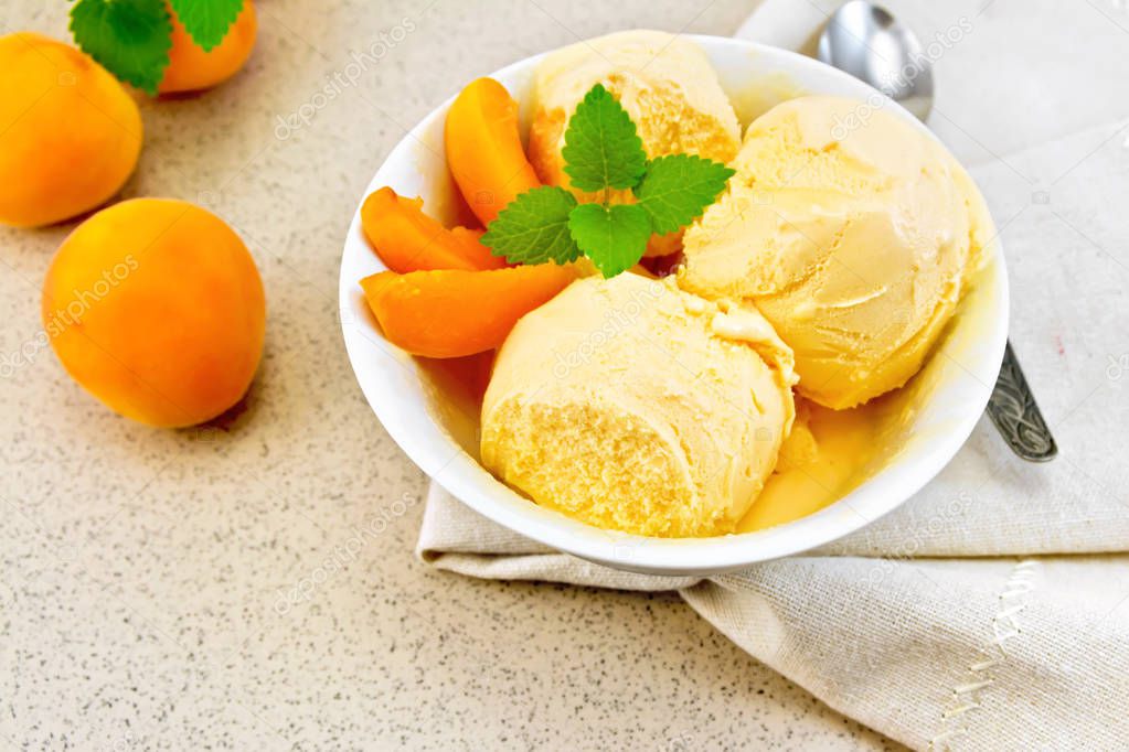 Ice cream apricot in white bowl on napkin
