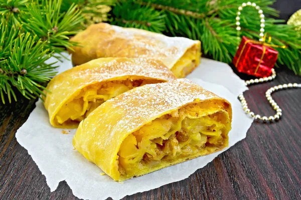 Strudel pumpkin and apple with Christmas toys on board — Stock Photo, Image