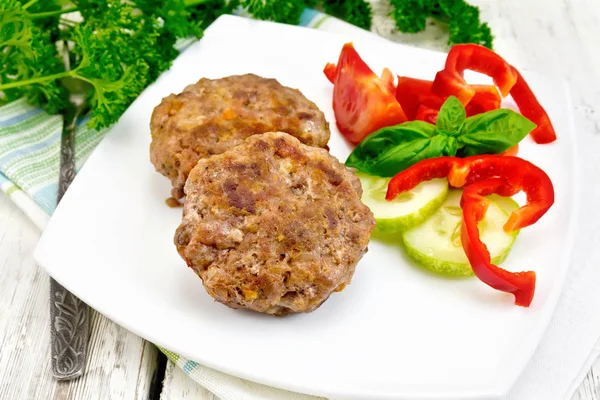 Cutlets stuffed with basil on light board — Stock Photo, Image