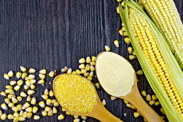 Flour and grits corn in spoons on wooden board — Stock Photo, Image