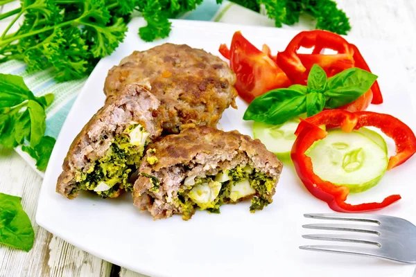 Cutlets stuffed with vegetables in plate on board — Stock Photo, Image