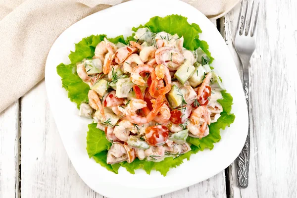 Salad with shrimp and avocado in plate on board top — Stock Photo, Image