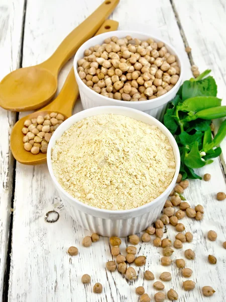 Flour chickpeas in white bowl with peas on board