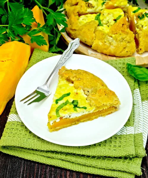 Pie of pumpkin and cheese in plate on dark board — Stock Photo, Image