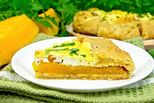 Pie of pumpkin and cheese in white plate on dark board — Stock Photo, Image