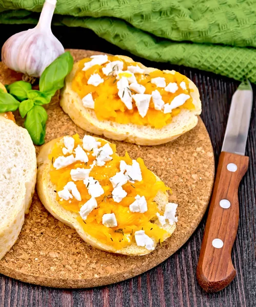 Bruschetta with pumpkin and cheese on dark board — Stock Photo, Image