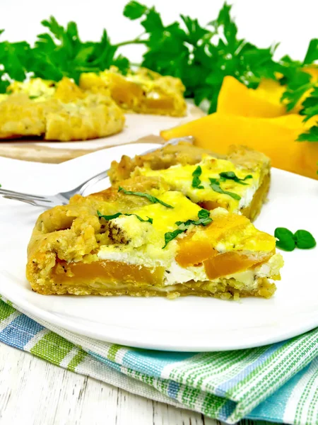 Pie of pumpkin and basil in plate on napkin — Stock Photo, Image