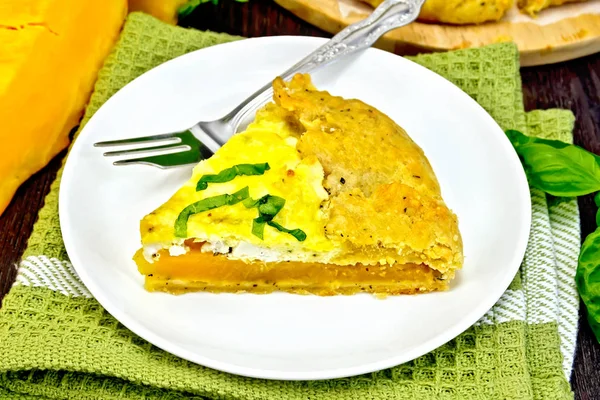 Pie of pumpkin and cheese in plate on green napkin — Stock Photo, Image