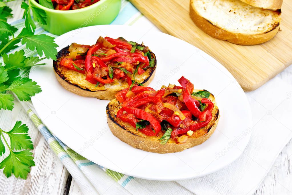 Bruschetta with tomatoes and peppers in plate on light board