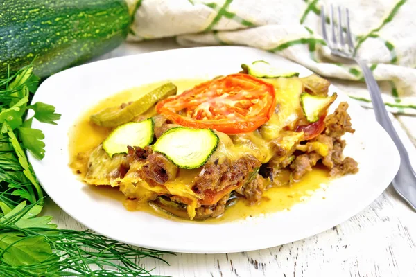 Casserole from minced meat and zucchini in plate on light board — Stock Photo, Image