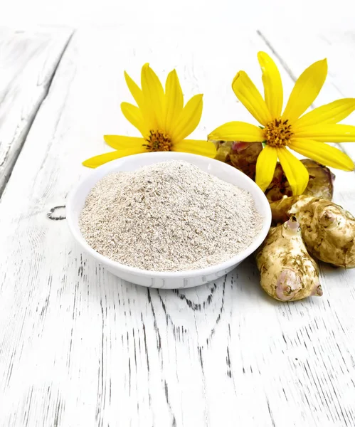 Flour of Jerusalem artichoke in white bowl with flower on board — Stock Photo, Image