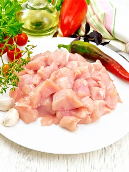 Chicken breast raw sliced in plate with vegetables on light boar — Stock Photo, Image