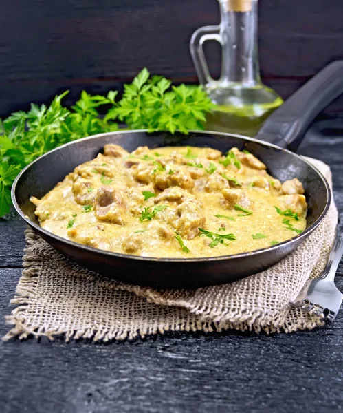 Meat stewed with cream on black board — Stock Photo, Image