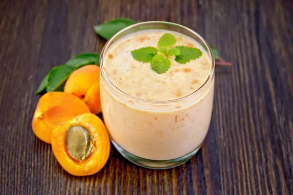 Milkshake apricot in glassful on board — Stock Photo, Image