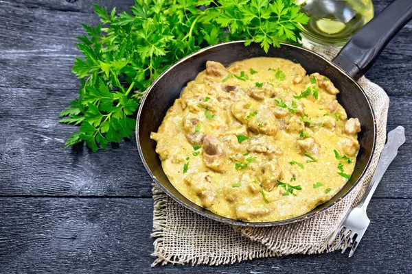 Meat stewed with cream in pan on black board — Stock Photo, Image