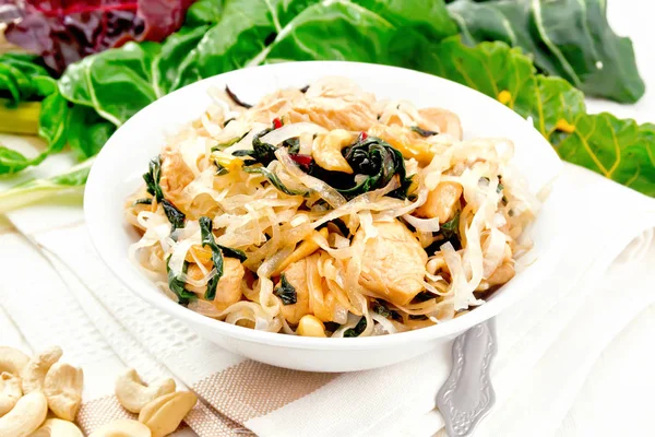 Funchoza with chard and cashew in bowl on light board — Stock Photo, Image