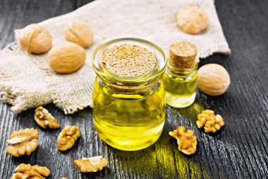 Oil walnut in jar with burlap on dark board