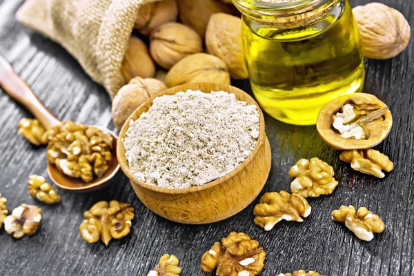 Flour walnut in bowl on dark board — Stock Photo, Image