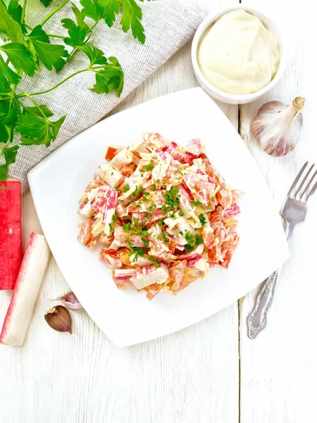 Salad of surimi and tomatoes with mayonnaise on board top — Stockfoto