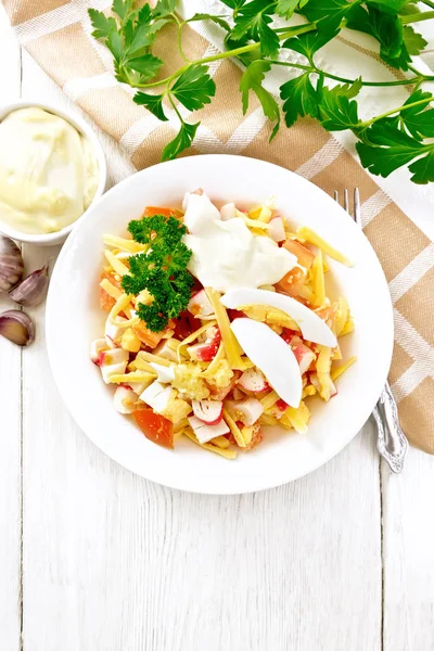 Salad of surimi and tomatoes with eggs on light board top — Stock Photo, Image