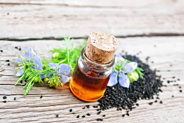 Nigella Sativa Olej Láhvi Semena Větvičky Černých Kmínu Semena Modrými — Stock fotografie