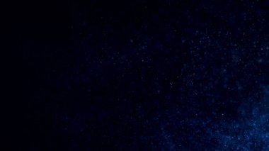 Parlayan parçacıklarla soyut arkaplan