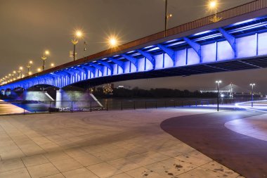 Polonya 'nın başkenti Varşova' da modern aydınlatma köprüsü. Vistula Nehri Bulvarları.